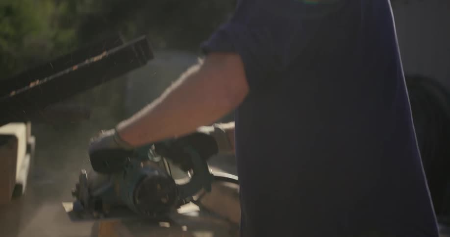 A man cuts would with a saw