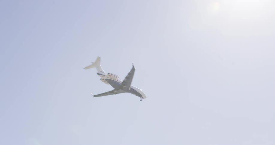 A plane with landing gear down flies overhead