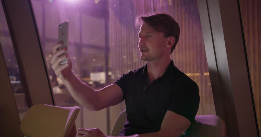 Man smiles and talks into a phone