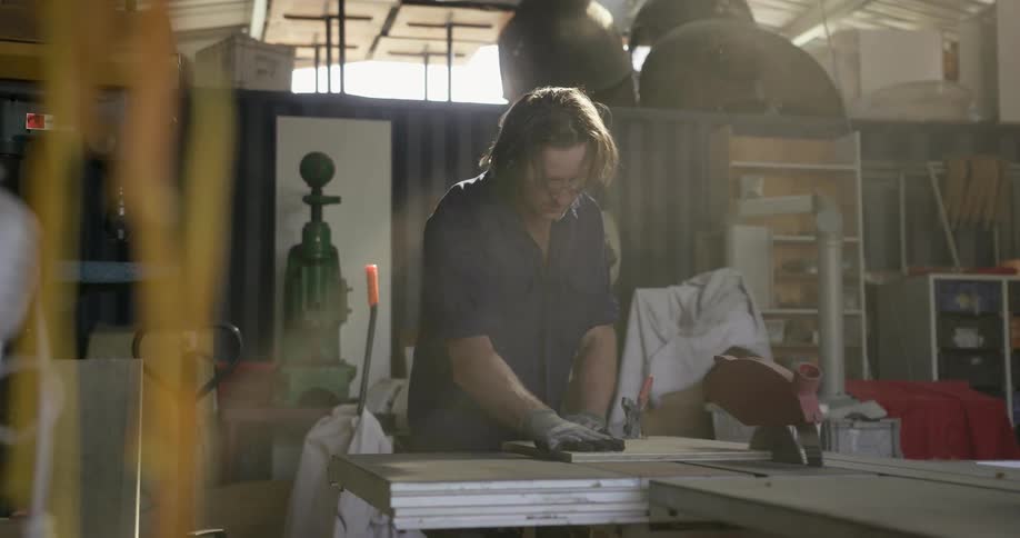 A man works in a wood workshop