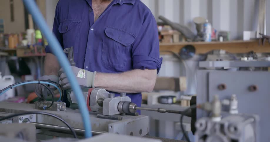 Men are working in a shop together with large machinery
