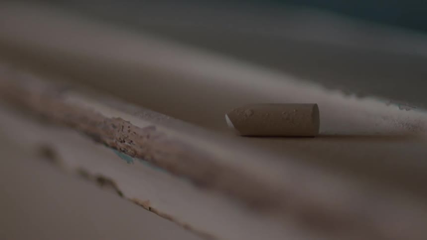 A piece of chalk sits on the ledge