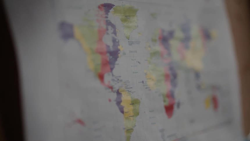 A map of the world is on the wall