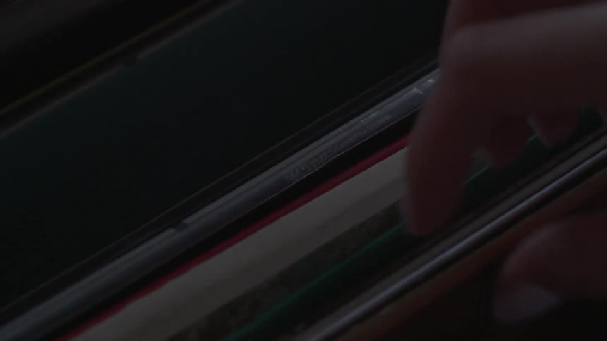 A woman flips through record albums and pulls one out