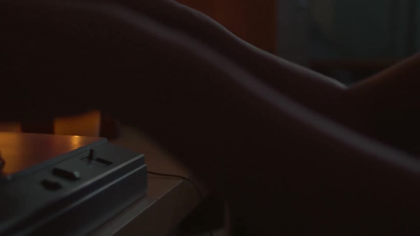 A person is examining a vinyl record