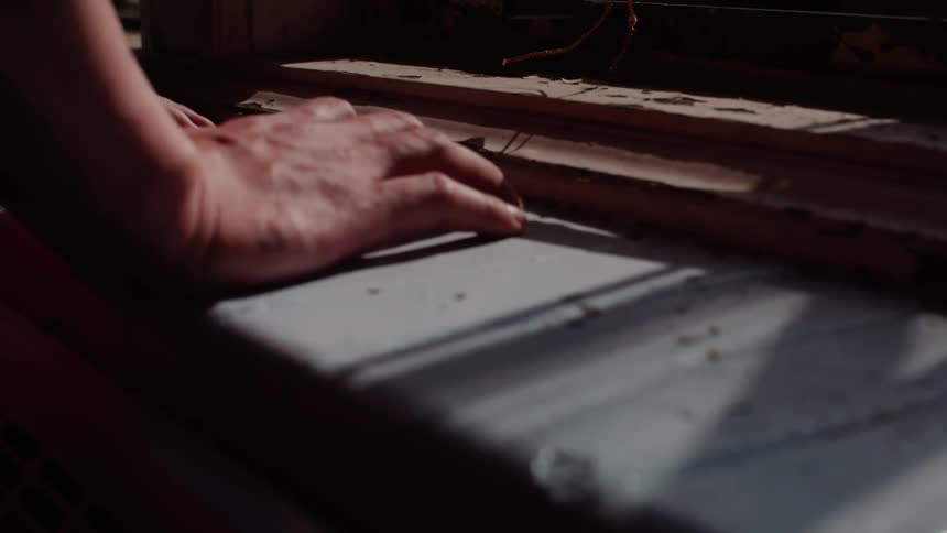 A person is leaning on the counter