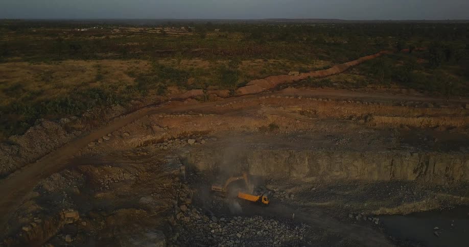 Smoke rises from an active construction site below