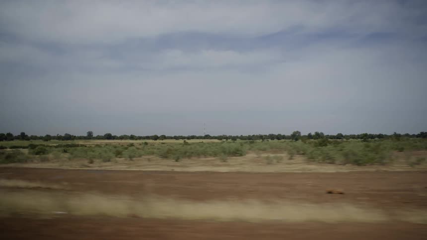 The field ahead is barren with only some green