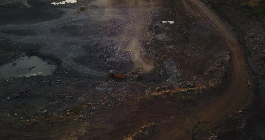 The work site below has steam rising from it by the vehicles