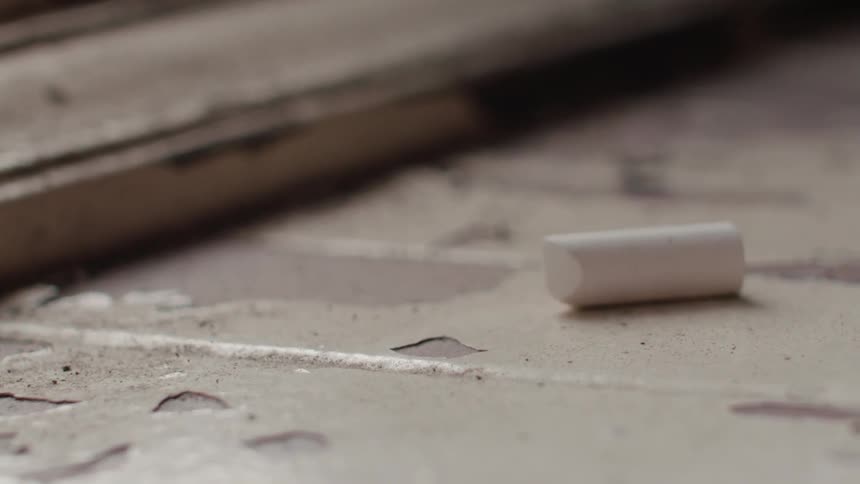 A piece of chalk is on the ground