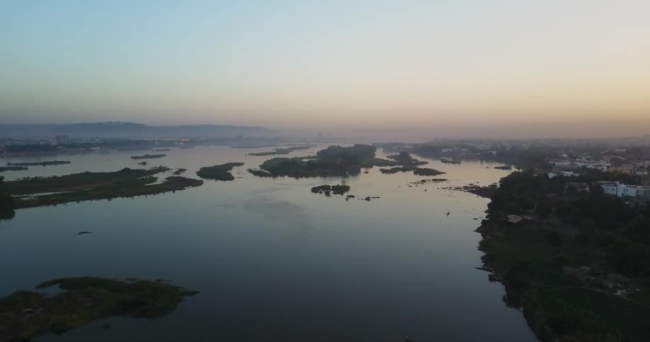 Haze hangs over a coastal area at dusk