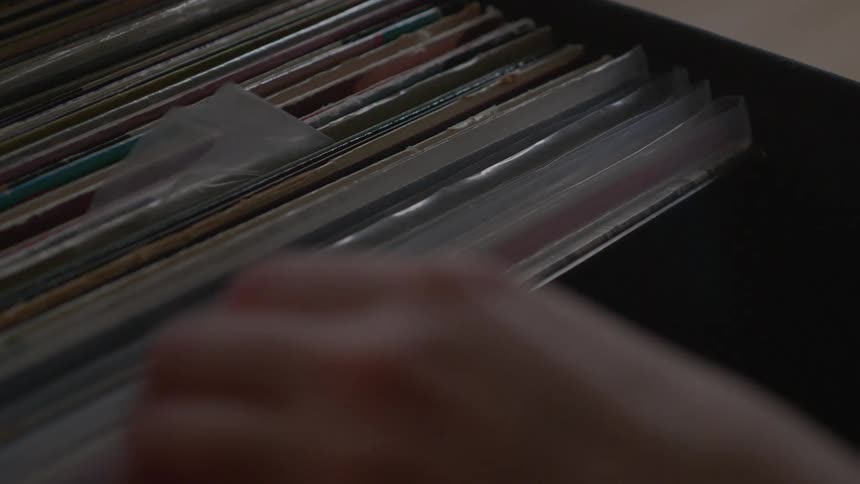 A person looks through a record collection