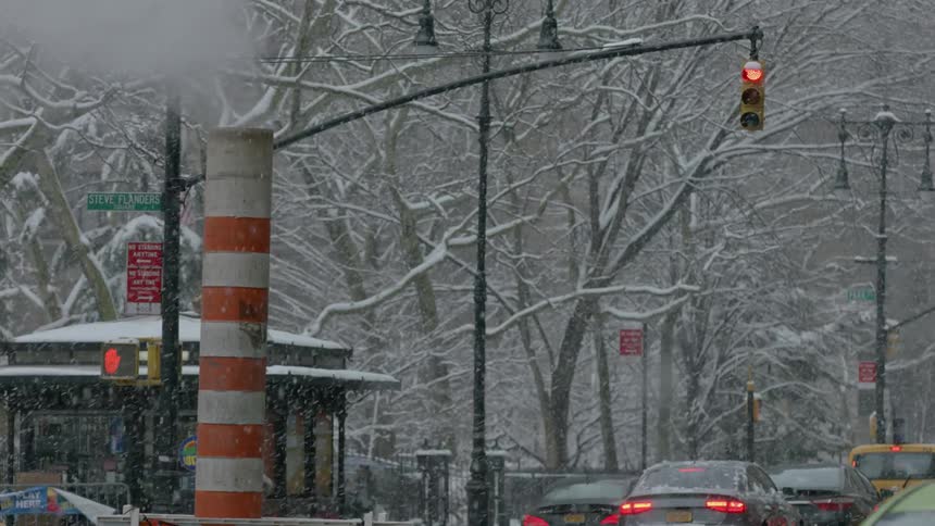 People walk in a city on a snowy day