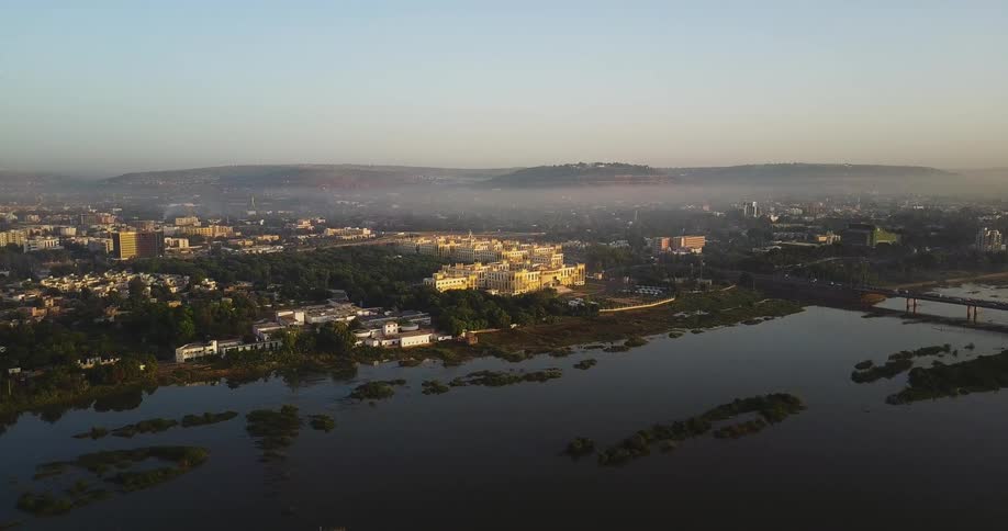 Aerial view of  a city next to a large river on a clear day