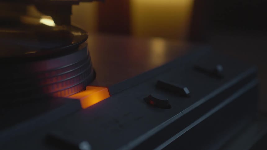 Woman adjusting the sound on record player
