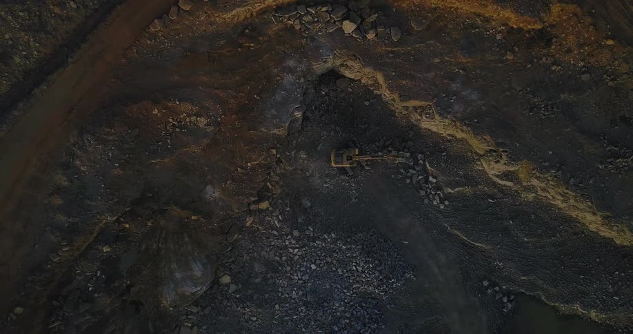 Tractor spinning near large rock piles
