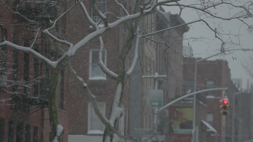 It is heavily snowing on this street