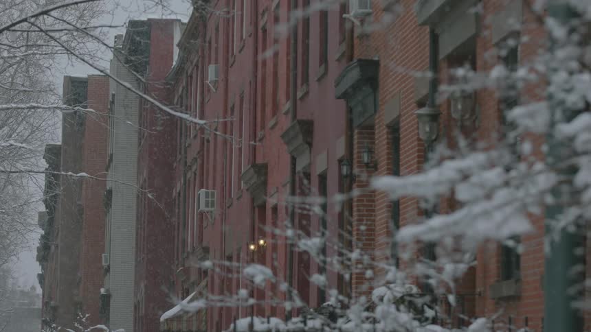 Snow falls in a city