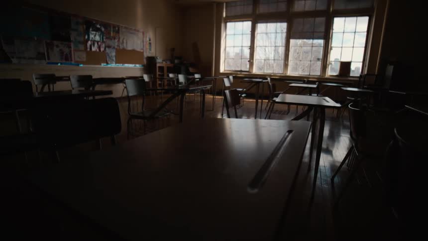 The window shades are up in an empty classroom