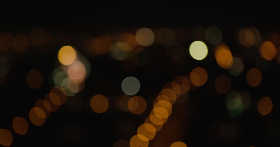 Blurry night time city lights are shown