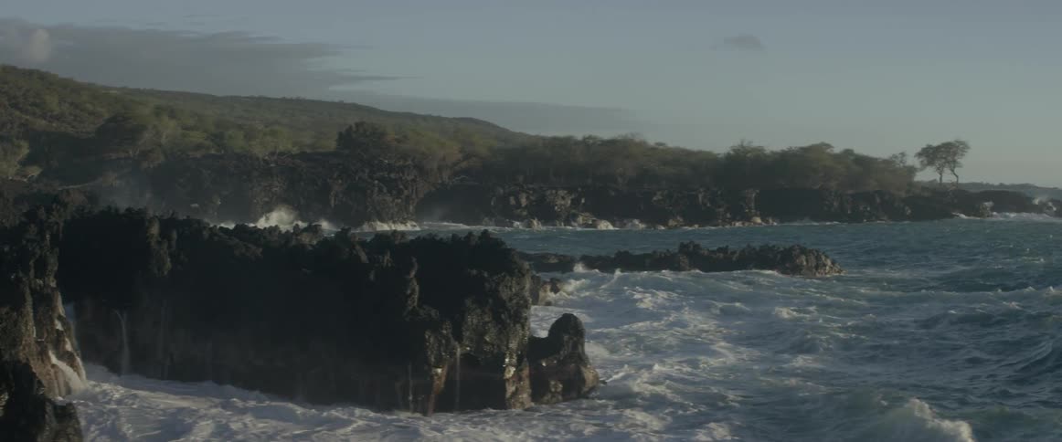 Ocean waves crash into a rocky shore