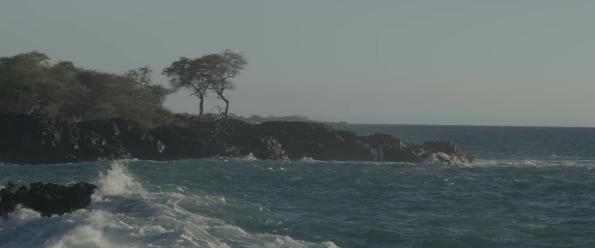 Ocean waves crash into a rocky shore