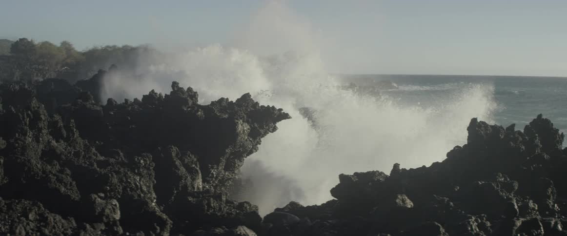 Ocean waves crash into a rocky shore