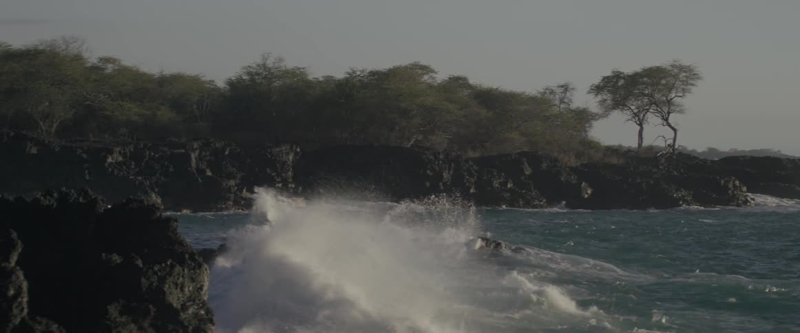Water splashing up on rocks on a sunny day