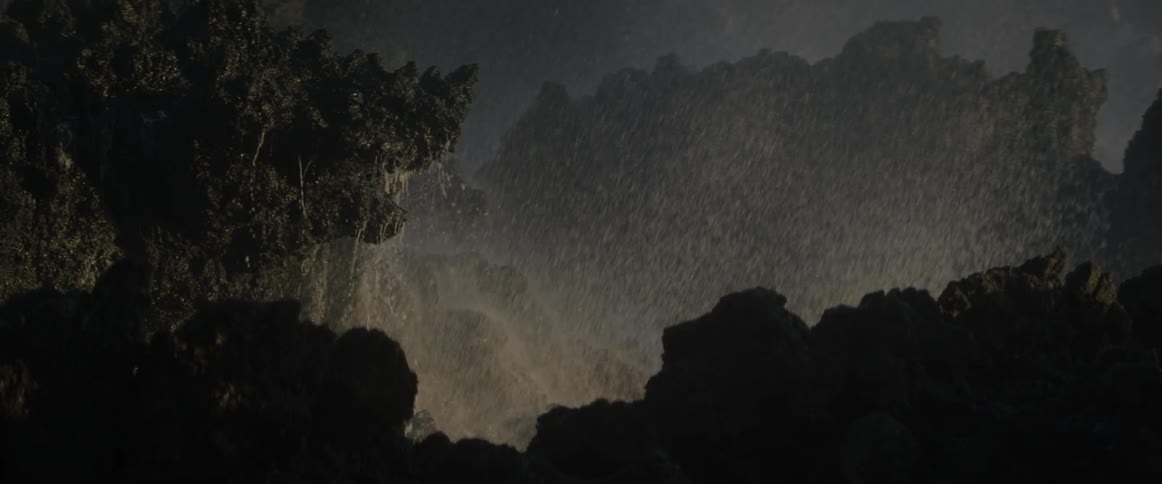The waves splash on the rocks rising high into the air