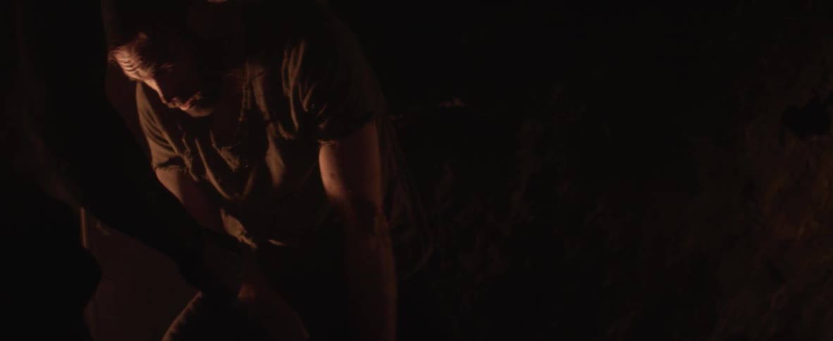 Man being struck by another in a dark area