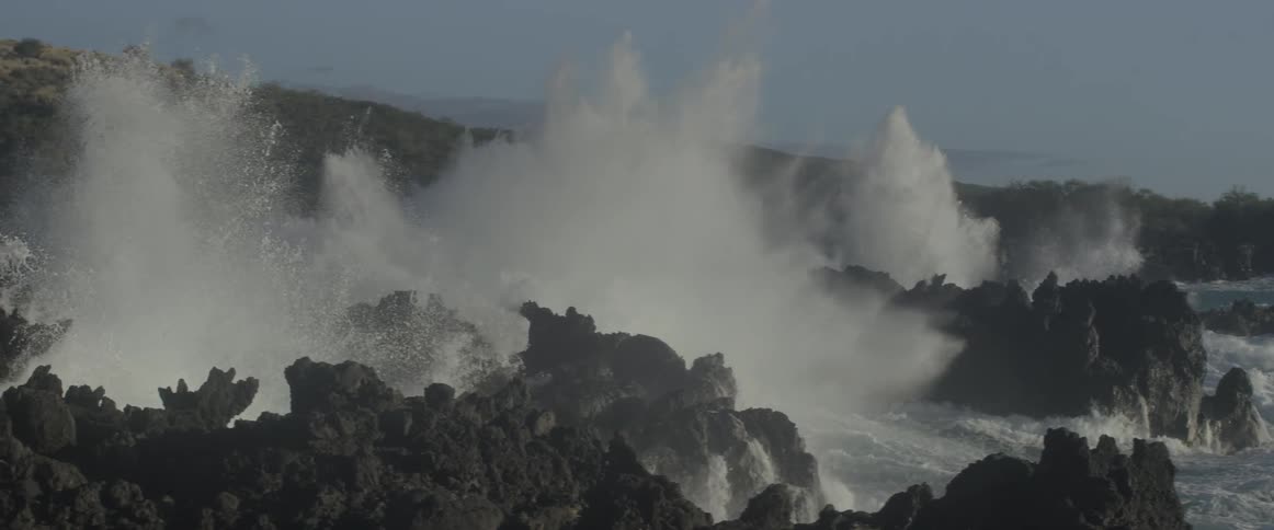 Ocean waves crash into a rocky shore
