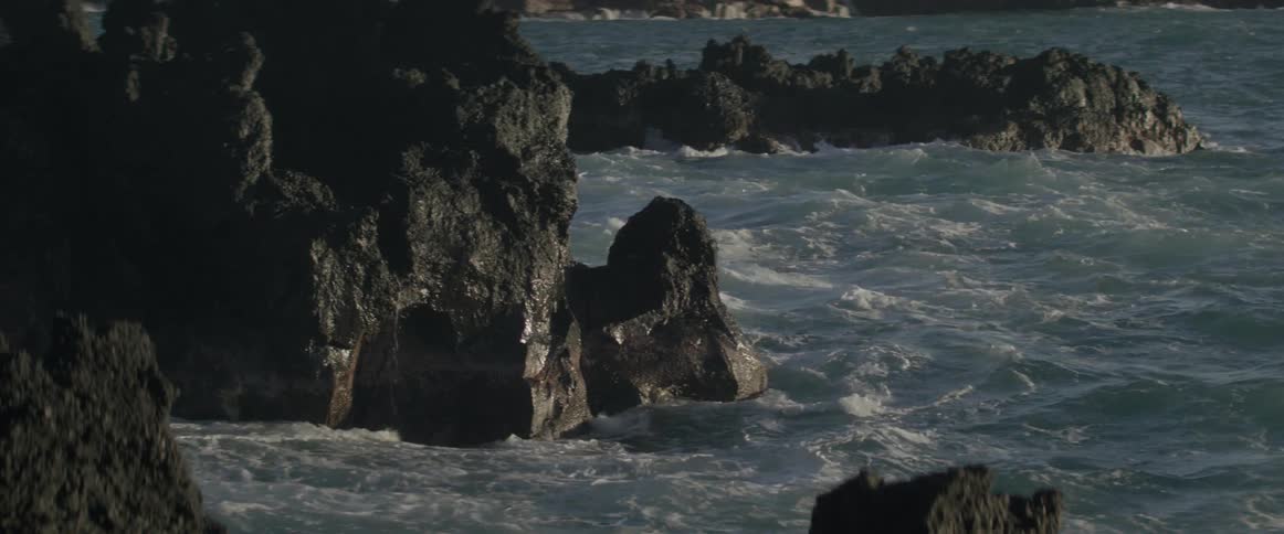 Ocean waves lap at rock outcroppings