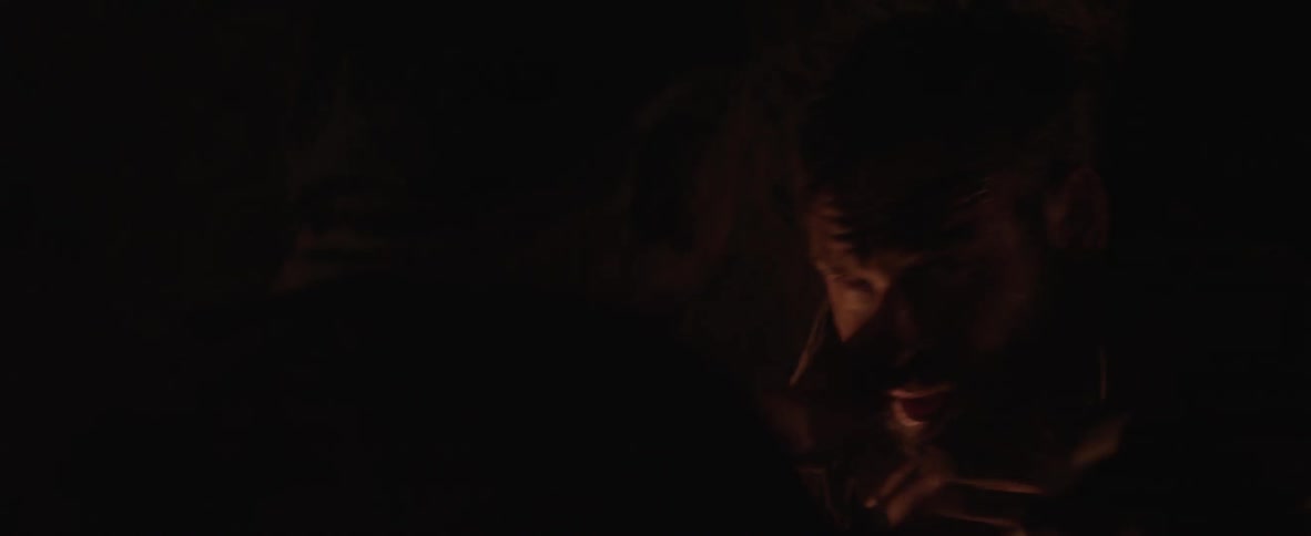 A chained up prisoner is attacked in a dark cave