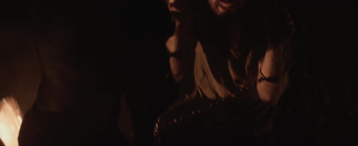 A man is chained and attacked in a dark cave