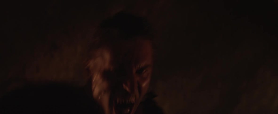 A man is violently attacked in a dark cave
