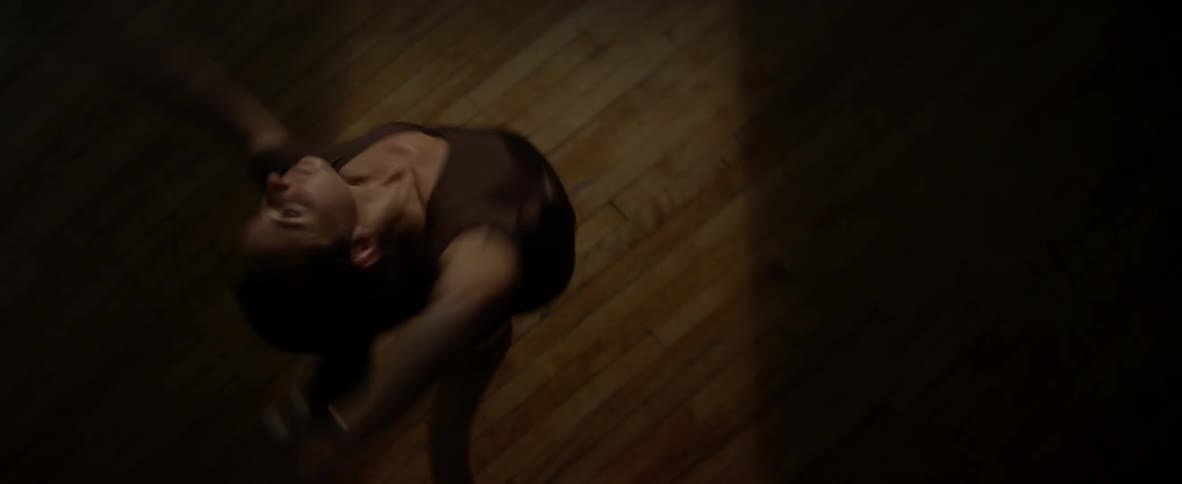 Woman dances spinning around in the dark