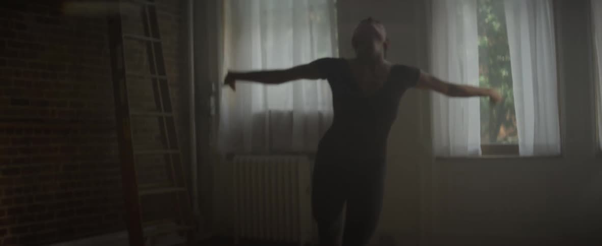 Woman dances in a sunlit room