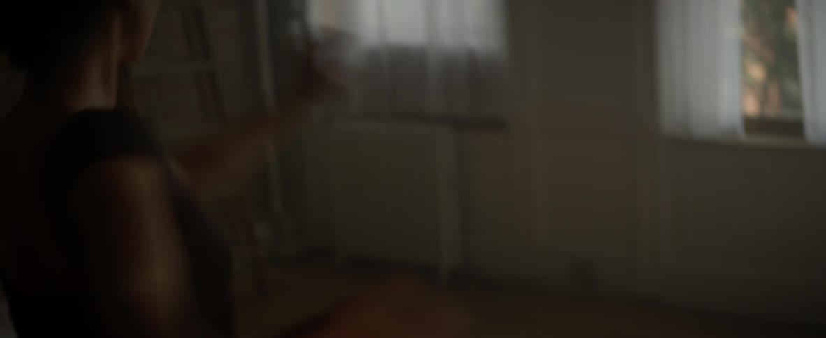 A woman is dancing in a dark studio