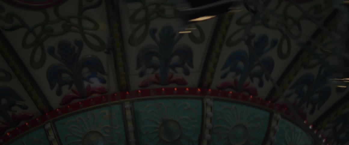 Carnival swing ride spins around and lights flash on it