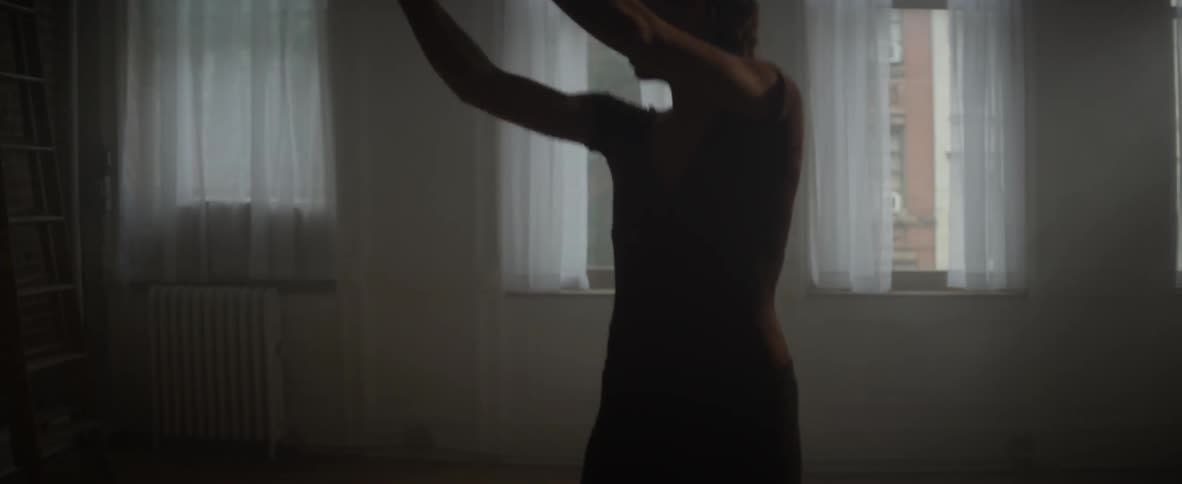 A woman spins around twisting and dancing