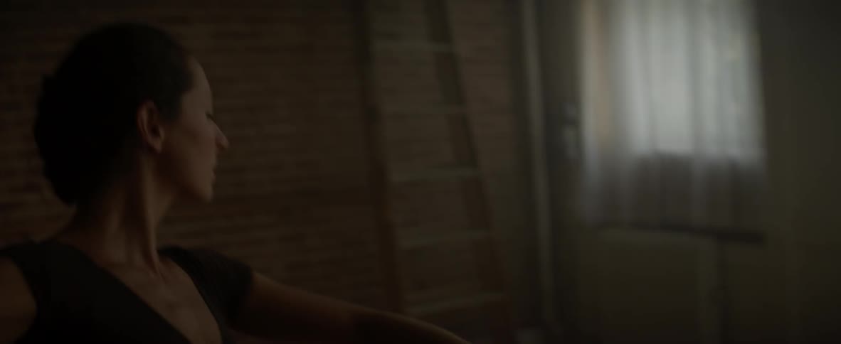 A ballerina dances in a studio
