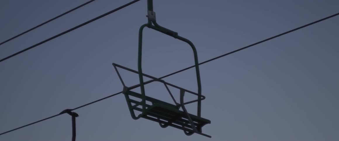 View of a seat hanging suspended by wires