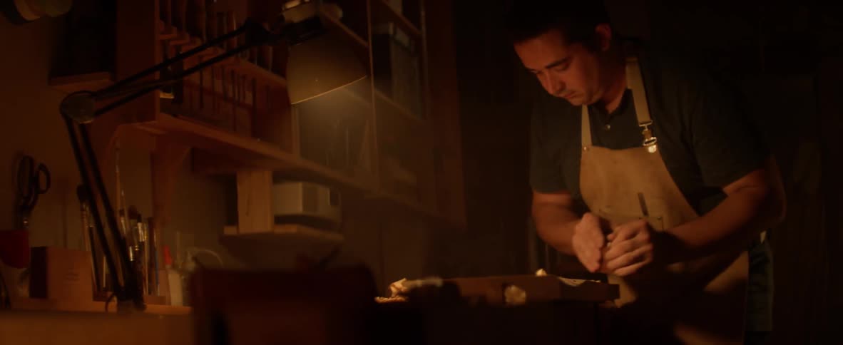 A man is cutting wood with a shaver