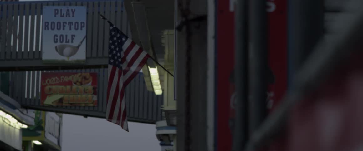 An american flag hangs from the side of a building