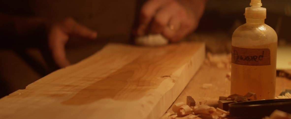 A man is polishing some wood with a cloth