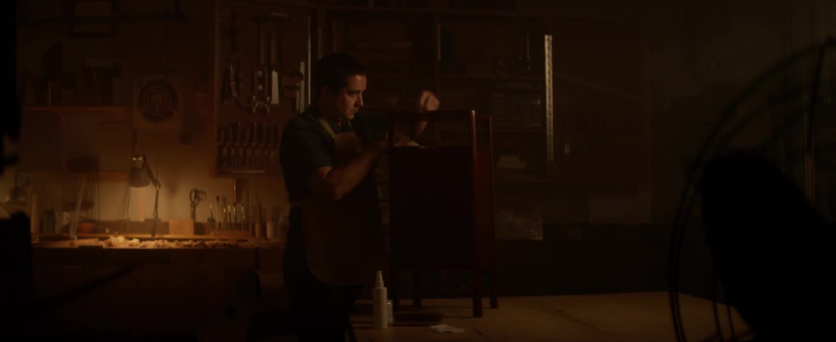 A man is working in a shop on furniture