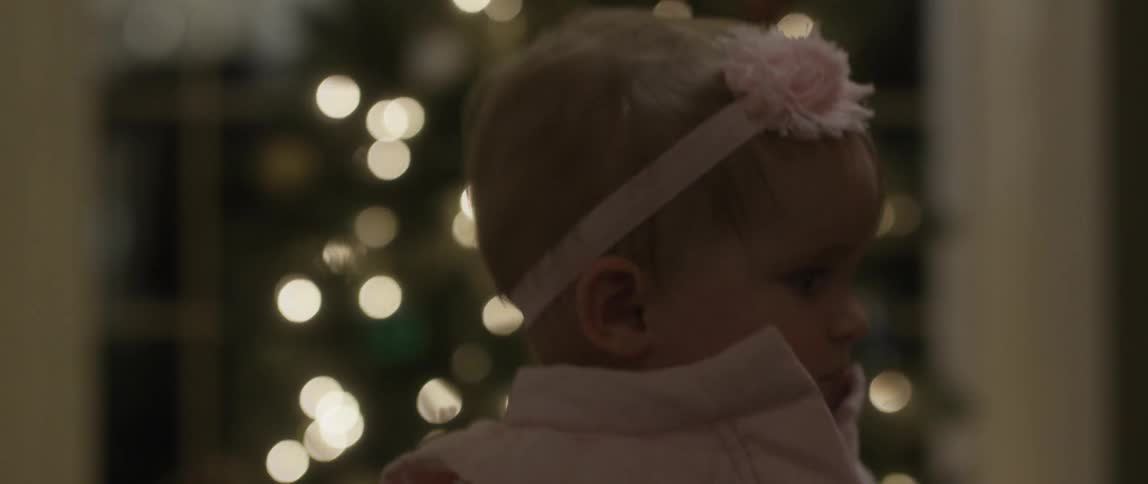 A baby wearing a pink headband