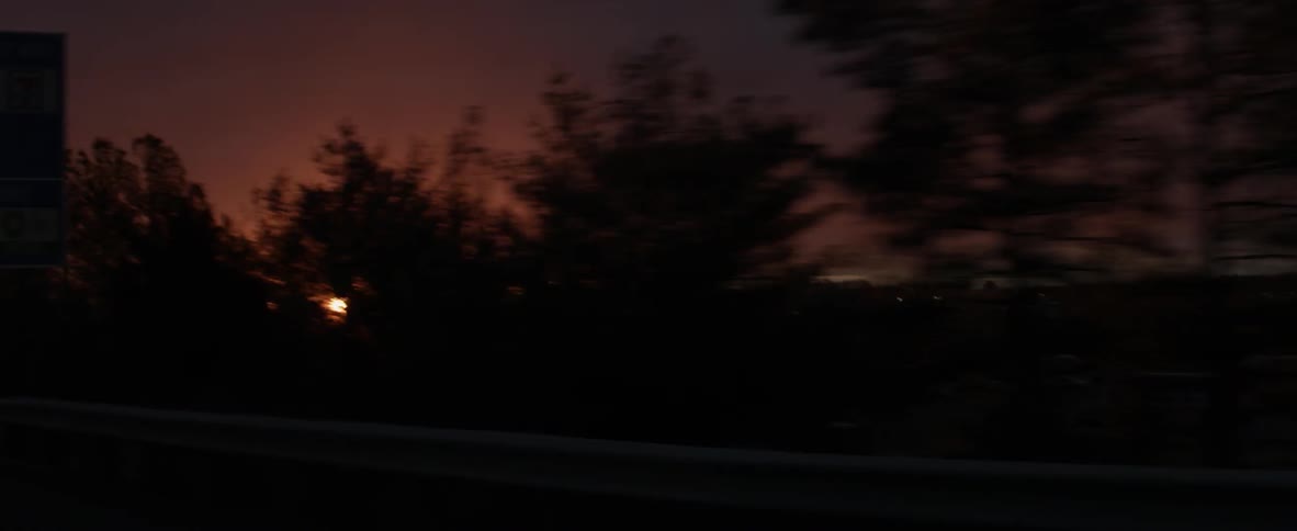 Driving past a building at sunset