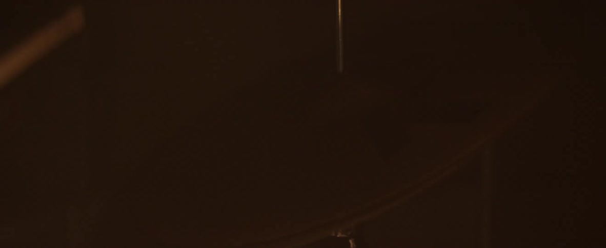 A person is swinging their arms in a dark room