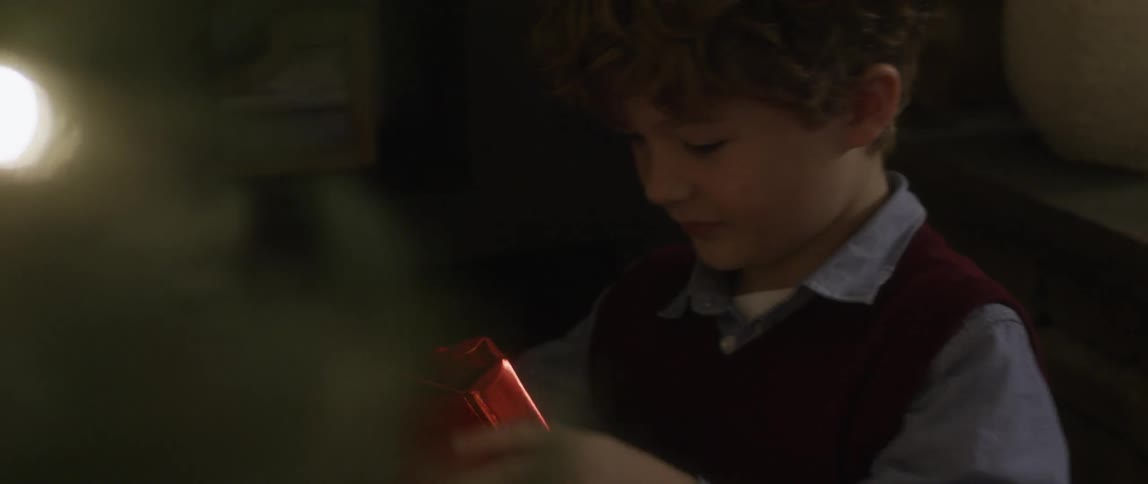 A child unwrapping a present